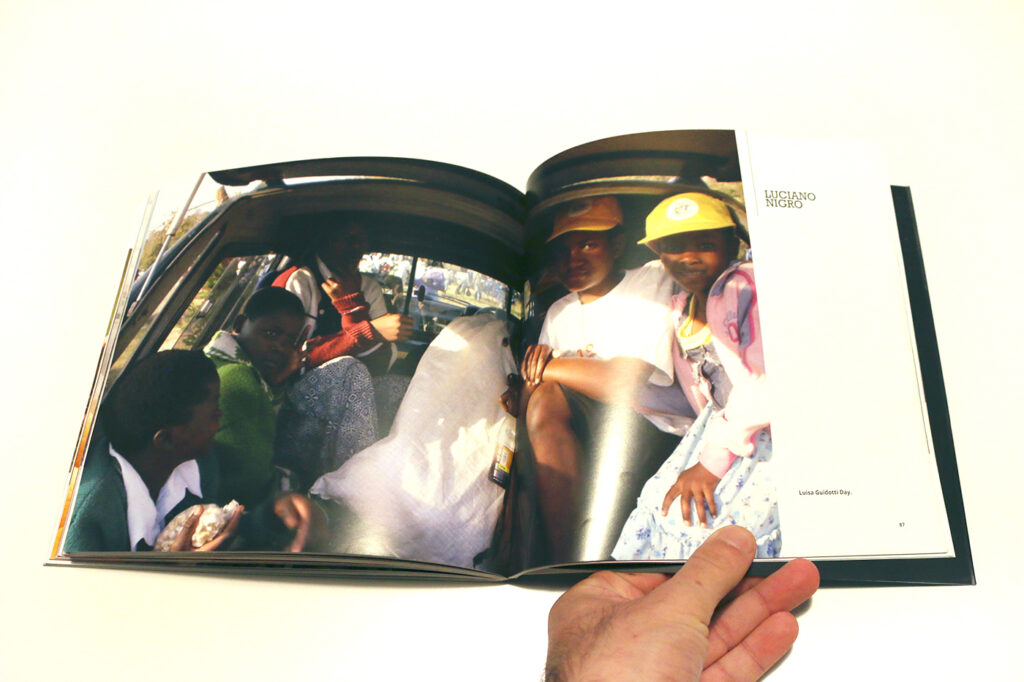 Internal page with a photograph of young adults in the back of a car going to Luisa Guidotti Day